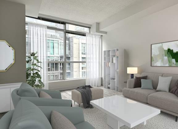 a living room with a gray couch and a white coffee table and a large window