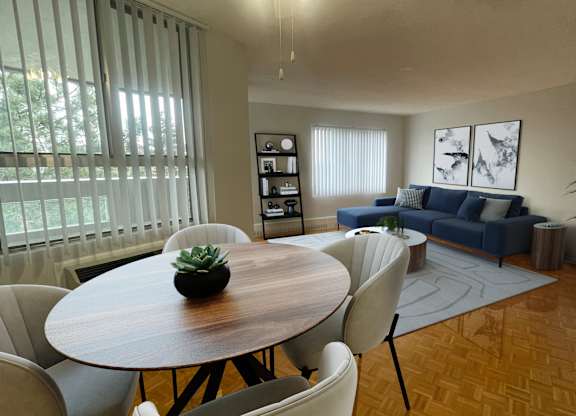 a living room and dining room with a table and chairs