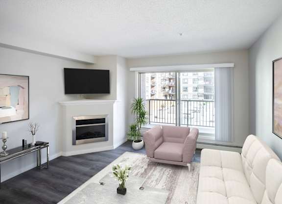 A living room with a fireplace, a couch, a chair, a potted plant, and a painting on the wall.