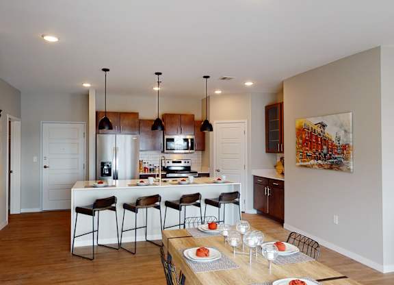 A modern kitchen with a dining table set for four.