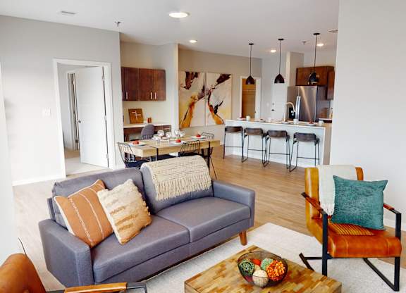 A living room with a grey couch and a wooden coffee table.