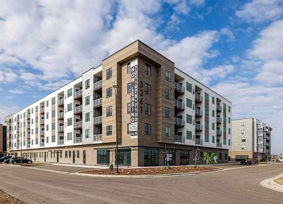 A large apartment building with the number 3 on the front.