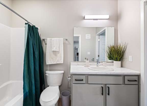 A bathroom with a white toilet, a white sink, and a white bathtub.