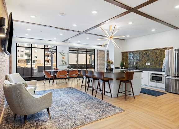 A modern kitchen with a dining table and chairs.