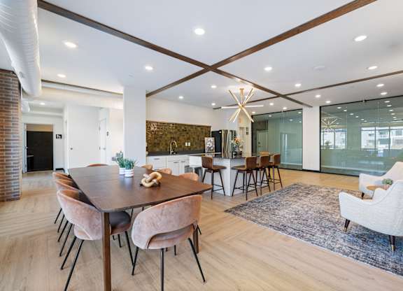 A modern dining room with a wooden table and chairs.