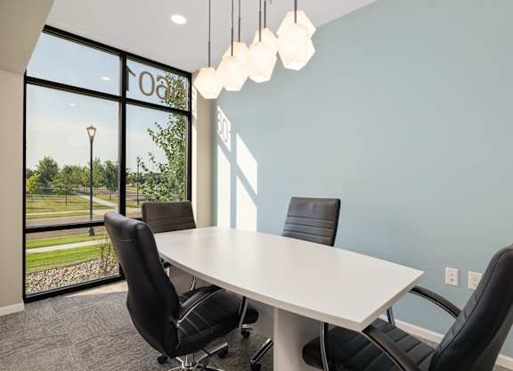 A conference room with a table and chairs.