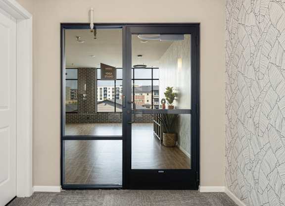 A black door with a glass window is open.