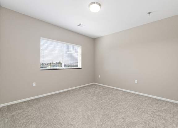 A room with a window and a ceiling light.
