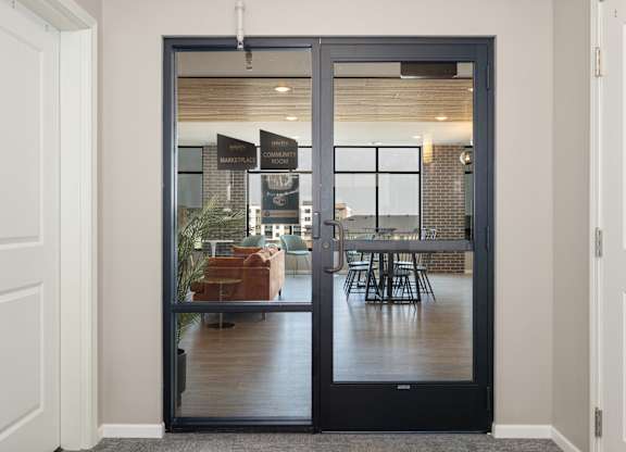 A glass door with a handle and a sign on it.