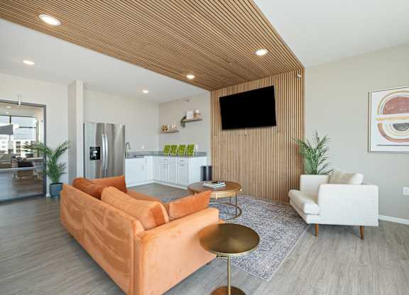 A living room with a couch, chair, and television.