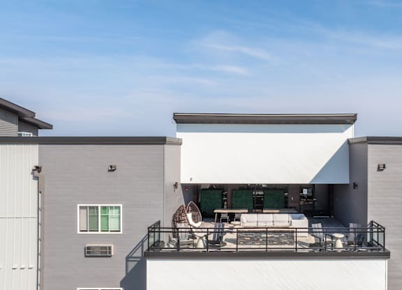 A modern house with a balcony and a white awning.