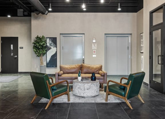 a lobby with a couch and two chairs at EagleRidge Plaza Residences, Fargo, North Dakota