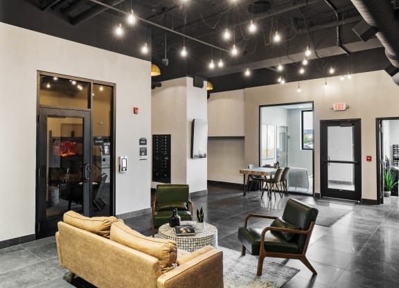 a living room with a couch and chairs and a dining room at EagleRidge Plaza Residences, Fargo