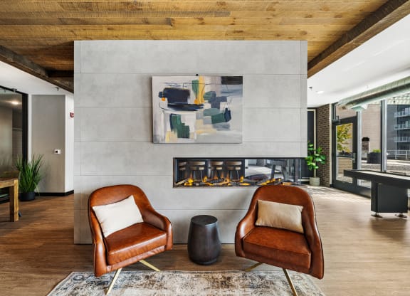 a living room with two chairs and a fireplace at EagleRidge Plaza Residences, Fargo, ND, 58104