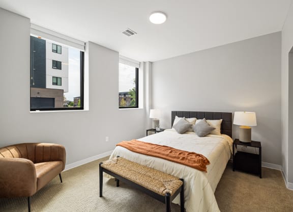 a bedroom with a large bed and two windows at EagleRidge Plaza Residences, North Dakota, 58104