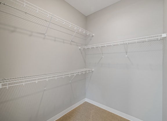 a spacious closet with shelves and hanging racks in an empty room at EagleRidge Plaza Residences, Fargo, ND