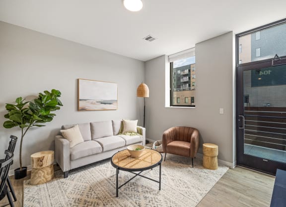 a living room with a white couch and a door to a balcony at EagleRidge Plaza Residences, Fargo, North Dakota