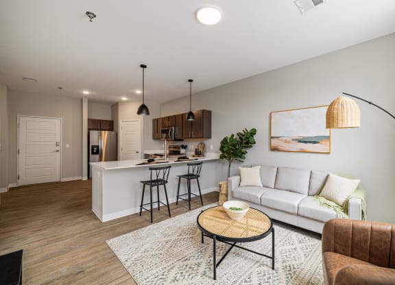 a living room with a couch and a kitchen with a bar at EagleRidge Plaza Residences, Fargo, ND, 58104