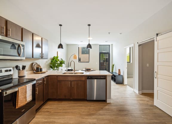 a large kitchen with wooden cabinets and a white counter top at EagleRidge Plaza Residences, Fargo, North Dakota