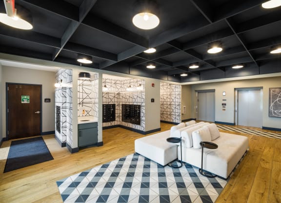 a living room with a white couch and a checkered rug at EagleRidge Plaza Residences, Fargo, North Dakota