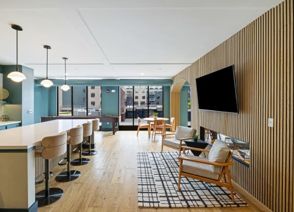 a lobby with a bar and chairs and a television at EagleRidge Plaza Residences, North Dakota, 58104