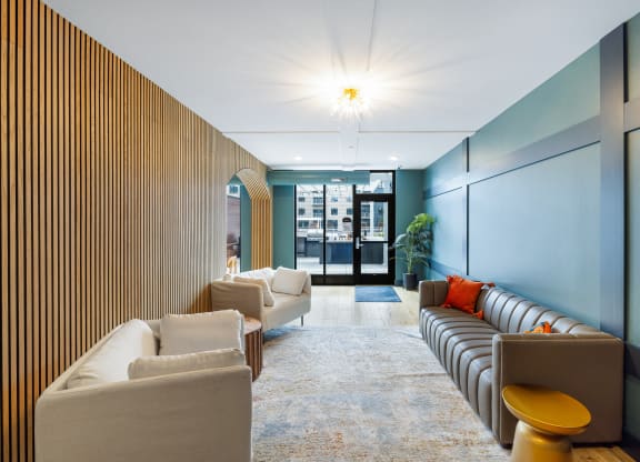 a lobby with couches and chairs and a wall with a door at EagleRidge Plaza Residences, Fargo, ND, 58104