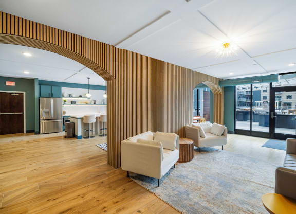 a living room with couches and chairs and a kitchen at EagleRidge Plaza Residences, Fargo, 58104