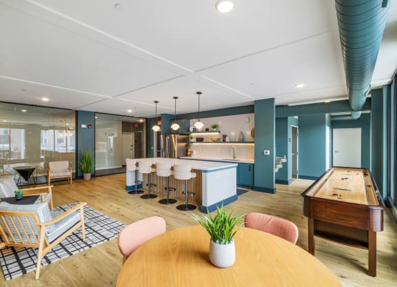 a living room with a table and chairs and a kitchen at EagleRidge Plaza Residences, Fargo, ND, 58104