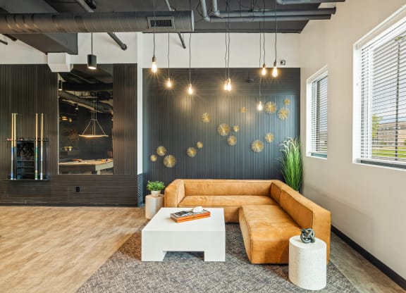 a living room with a brown couch and a white coffee table at EagleRidge Plaza Residences, North Dakota, 58104