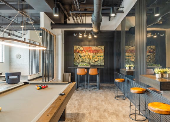 a game room with a pool table and a bar at EagleRidge Plaza Residences, North Dakota