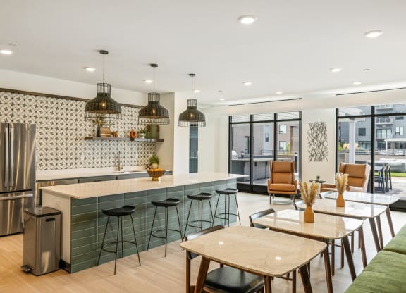 a kitchen and dining area with a counter and stools at EagleRidge Plaza Residences, North Dakota