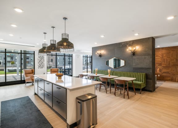 a communal kitchen and dining area with a table and chairs at EagleRidge Plaza Residences, Fargo, 58104