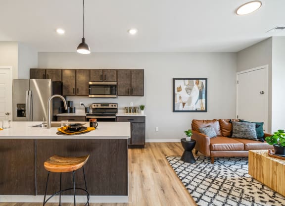 a living room with a kitchen and a couch at EagleRidge Plaza Residences, Fargo, North Dakota