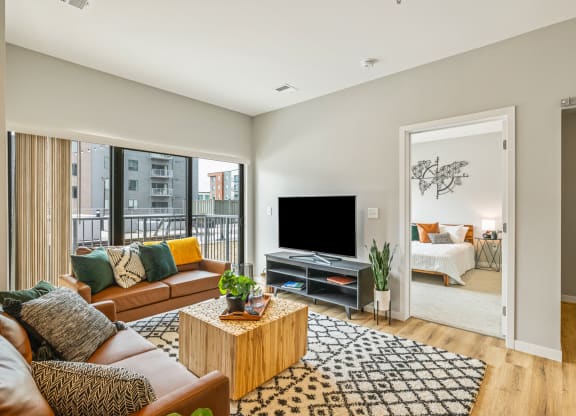 a living room with a couch and a tv at EagleRidge Plaza Residences, Fargo, ND