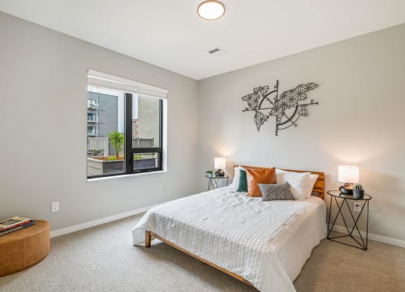 a bedroom with a bed and a large window at EagleRidge Plaza Residences, Fargo, 58104