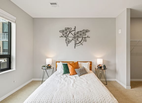 a bedroom with a bed and a wall art above it at EagleRidge Plaza Residences, Fargo