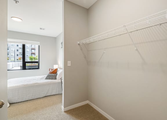 a closet in a bedroom with a bed and a window at EagleRidge Plaza Residences, North Dakota