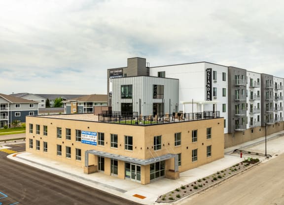 an aerial view of an apartment building with a rooftop terrace at The Standard on 32nd, North Dakota, 58078