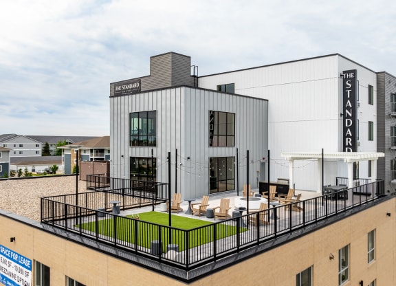 a rendering of a building with a rooftop terrace at The Standard on 32nd, West Fargo, ND