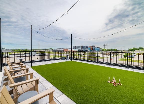 the rooftop patio with lawn chairs and a view of the city at The Standard on 32nd, West Fargo