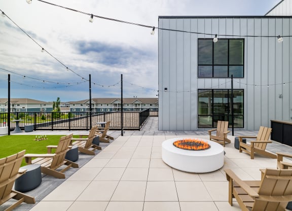 a patio with wooden chairs and a fire pit at The Standard on 32nd, West Fargo, 58078