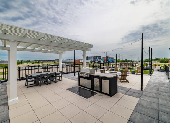 a patio with tables and chairs and a grill at The Standard on 32nd, North Dakota