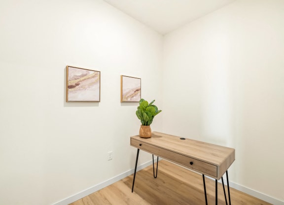 a room with a wooden table and two paintings on the wall at The Standard on 32nd, West Fargo, ND, 58078