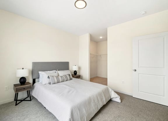 a bedroom with a large bed and a closet at The Standard on 32nd, West Fargo