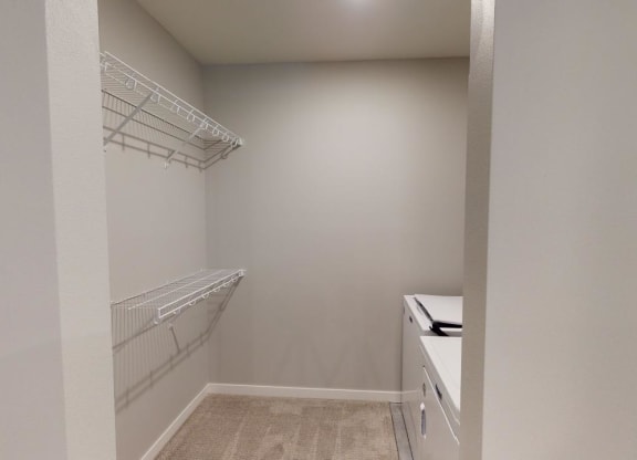 a walk in closet in a home with white walls and shelvesat Northern Lights a Lifestyle-Driven Community, West Fargo, 58078