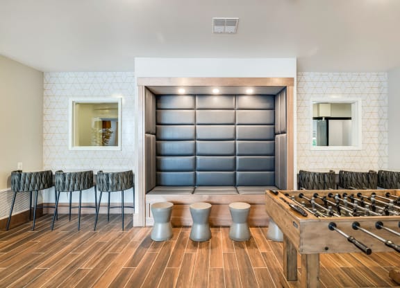 a game room with a foosball table and chairsat Northern Lights a Lifestyle-Driven Community, West Fargo, ND, 58078