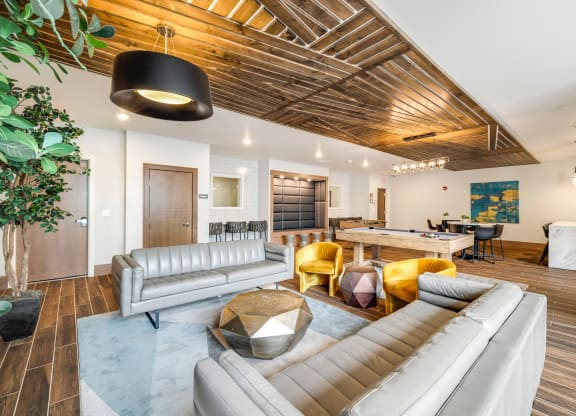 a living room with couches and chairs and a tableat Northern Lights a Lifestyle-Driven Community, West Fargo, 58078