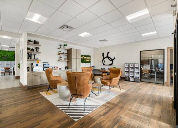 the waiting room of a salon with chairs and a table at Northern Lights a Lifestyle-Driven Community, West Fargo, ND
