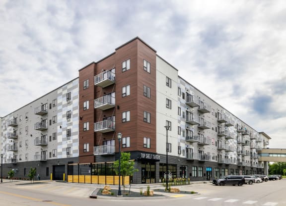 a large apartment building on the corner of a city street at Northern Lights a Lifestyle-Driven Community, West Fargo, ND