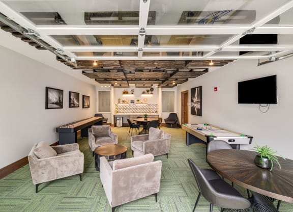 a living room with chairs tables and a pool tableat Northern Lights a Lifestyle-Driven Community, West Fargo, ND